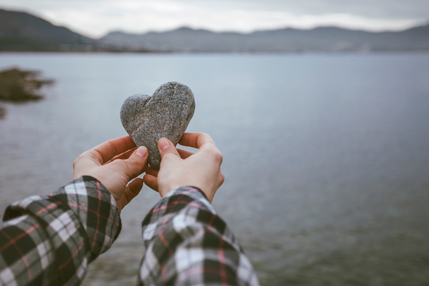 woman holding heart shaped rock