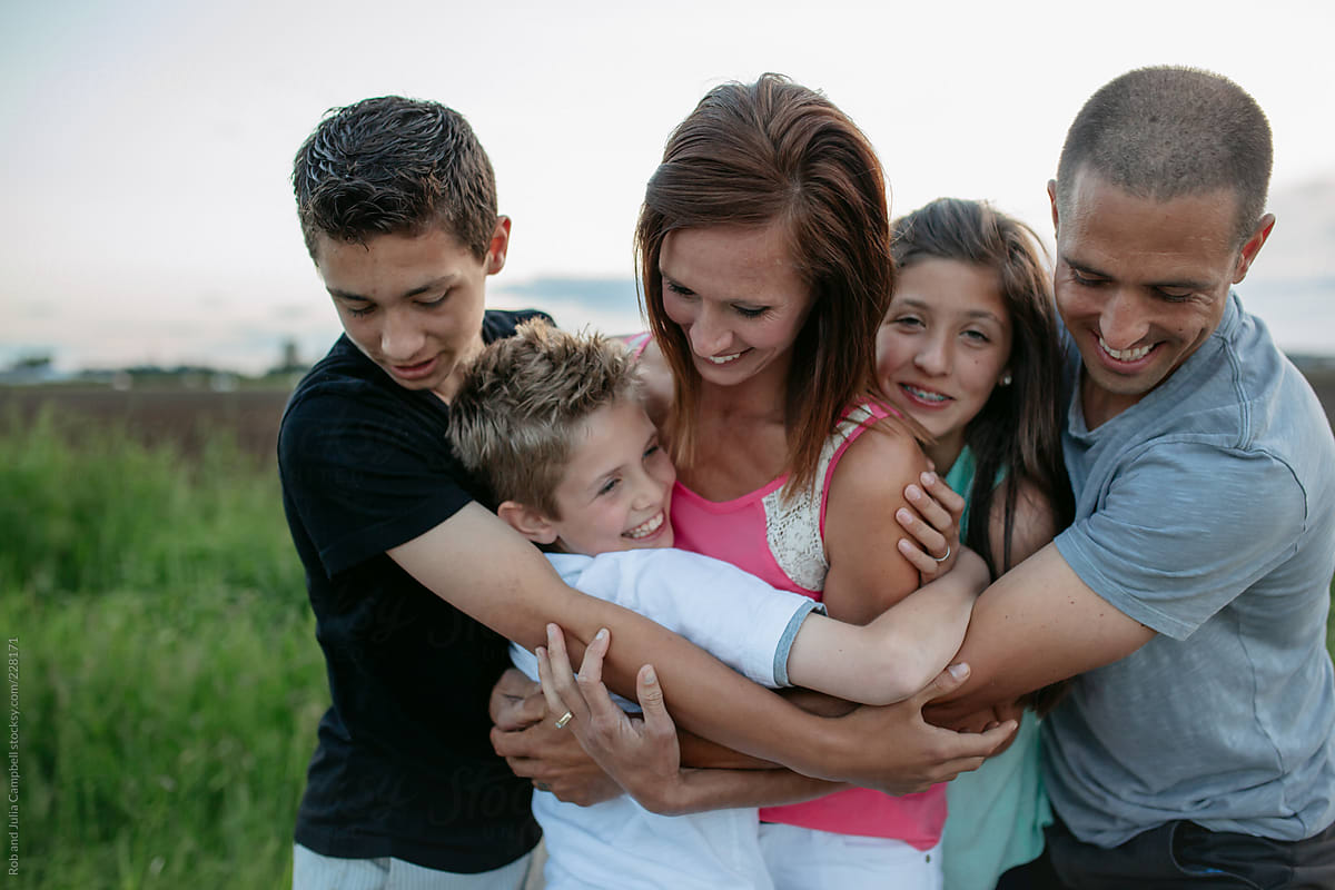 They are relaxed and enjoying each other as a family unit.