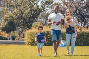 A mixed-race family walking in a park with European flags (P044728-798775) by Xavier Lejeune / EC - Audiovisual Service is licensed under CC BY 4.0.